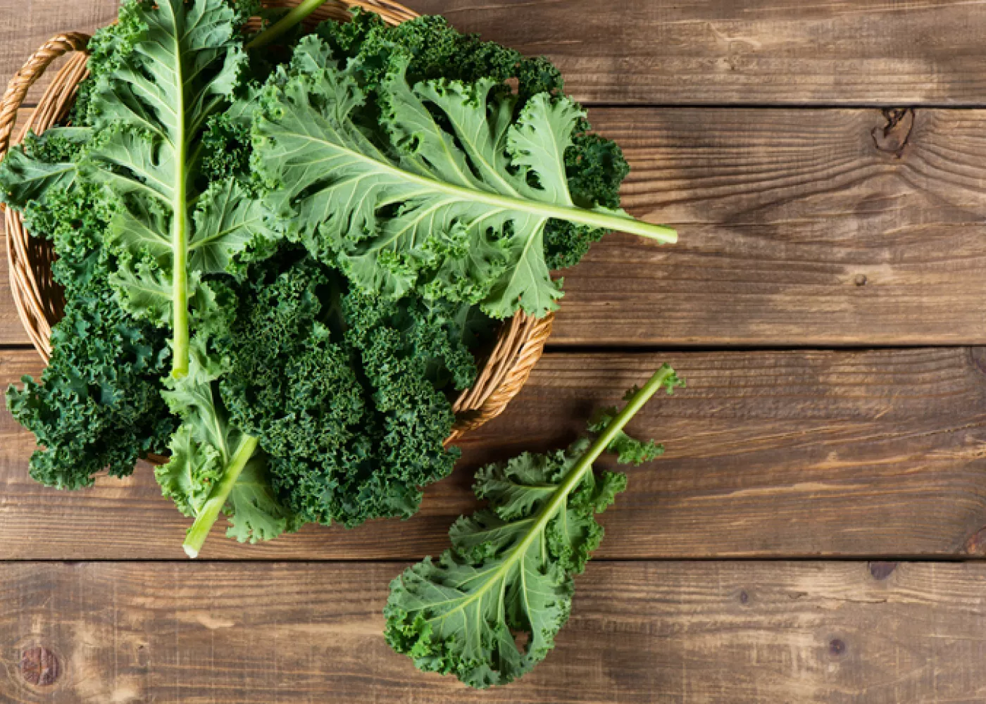 Fresh kale leaves in a rustic basket